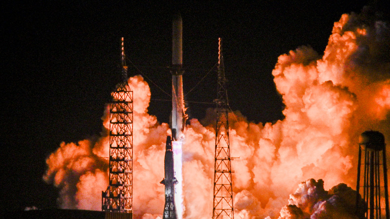 A Blue Origin New Glenn rocket lifts off at night