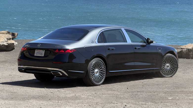Rear 3/4 view of a grey and black 2027 Mercedes-Maybach S680